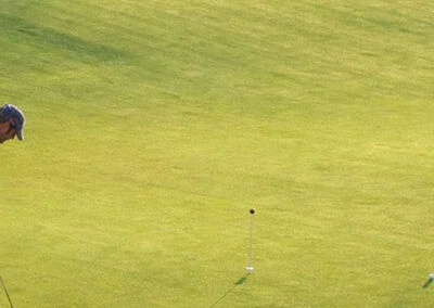A view of the green at Falcon Lakes Golf Course with a hole and pin visible.
