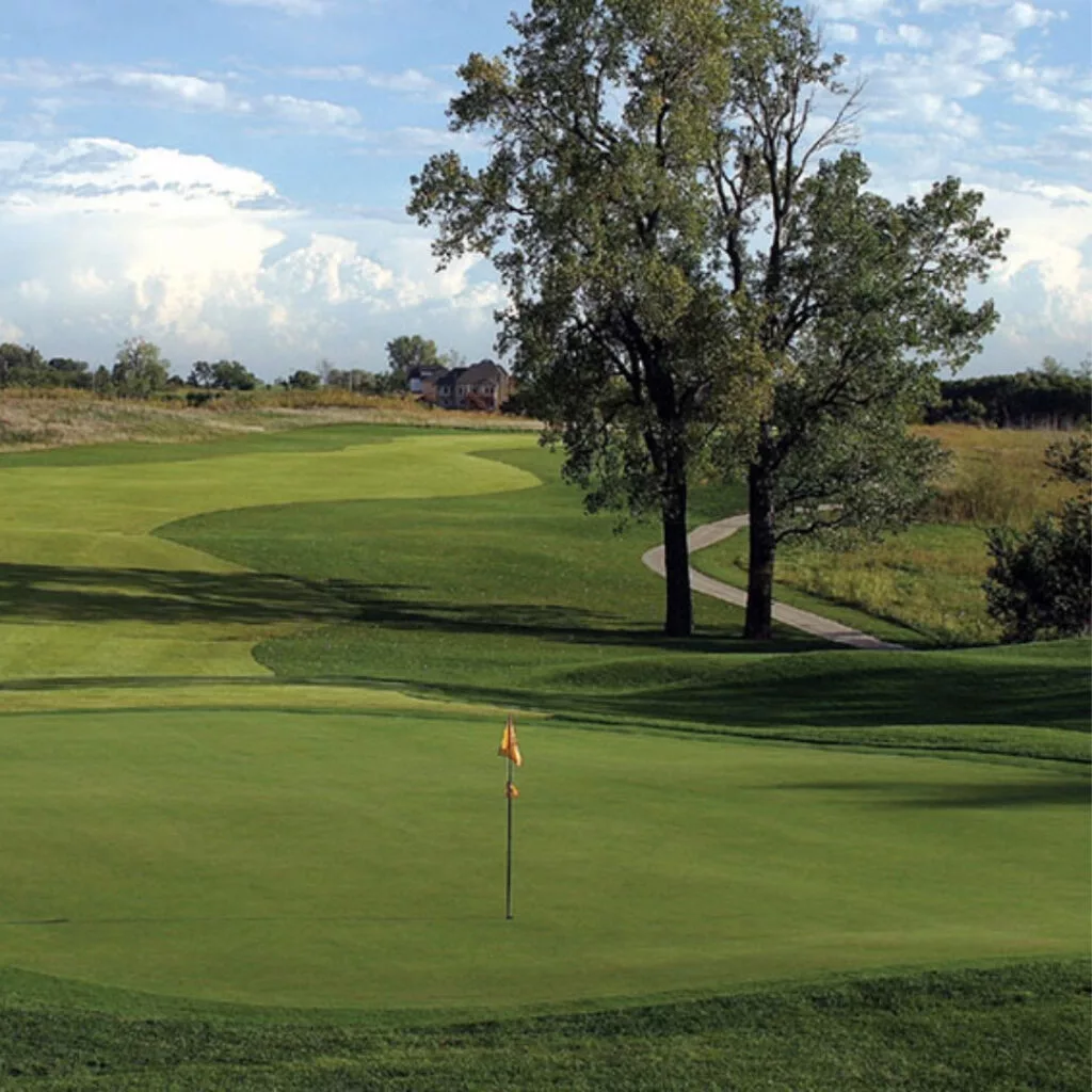 A view of a pin and green at Falcon Lakes Golf Club.