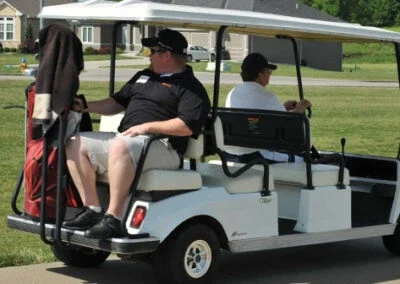 Riders using a golf cart.