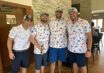 A group of golfers stand for a photo in the Falcon Lakes Golf Course Clubhouse.