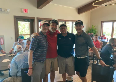 A group of golfers stand for a photo in the Falcon Lakes Golf Course Clubhouse.