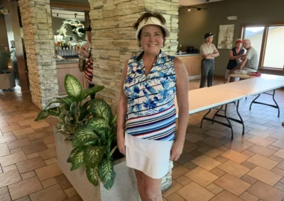 A golfer stands for a photo in the Falcon Lakes Golf Course Clubhouse.