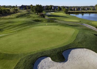 Aerial photo of Falcon Lakes Golf Course showing fairway, bunkers, lake, and green.